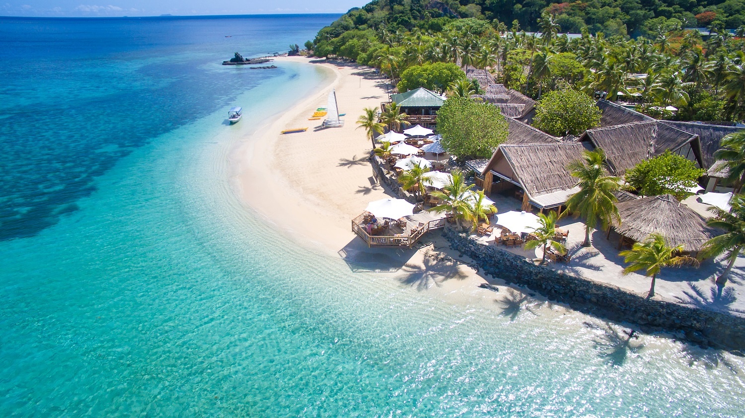 A resort by the beach next to the clear water
