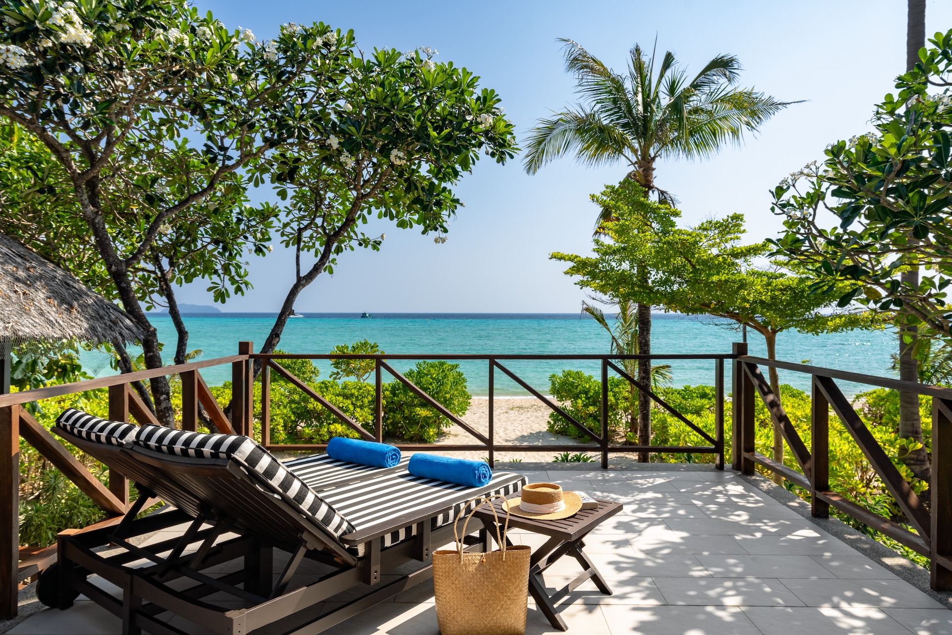 A private balcony with a sunbed and a view of the ocean